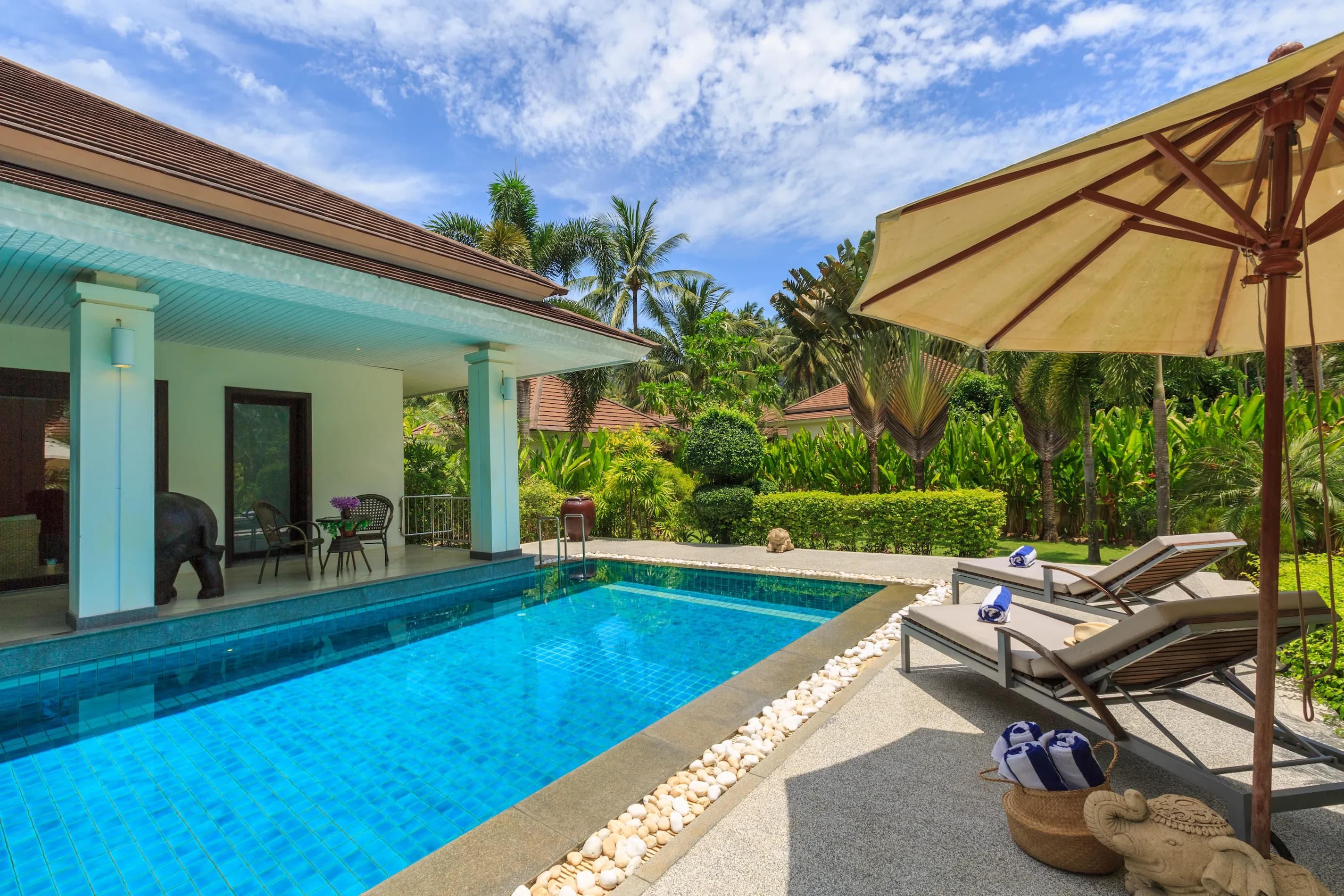 Sun drenched pool deck leading to spacious landscaped gardens