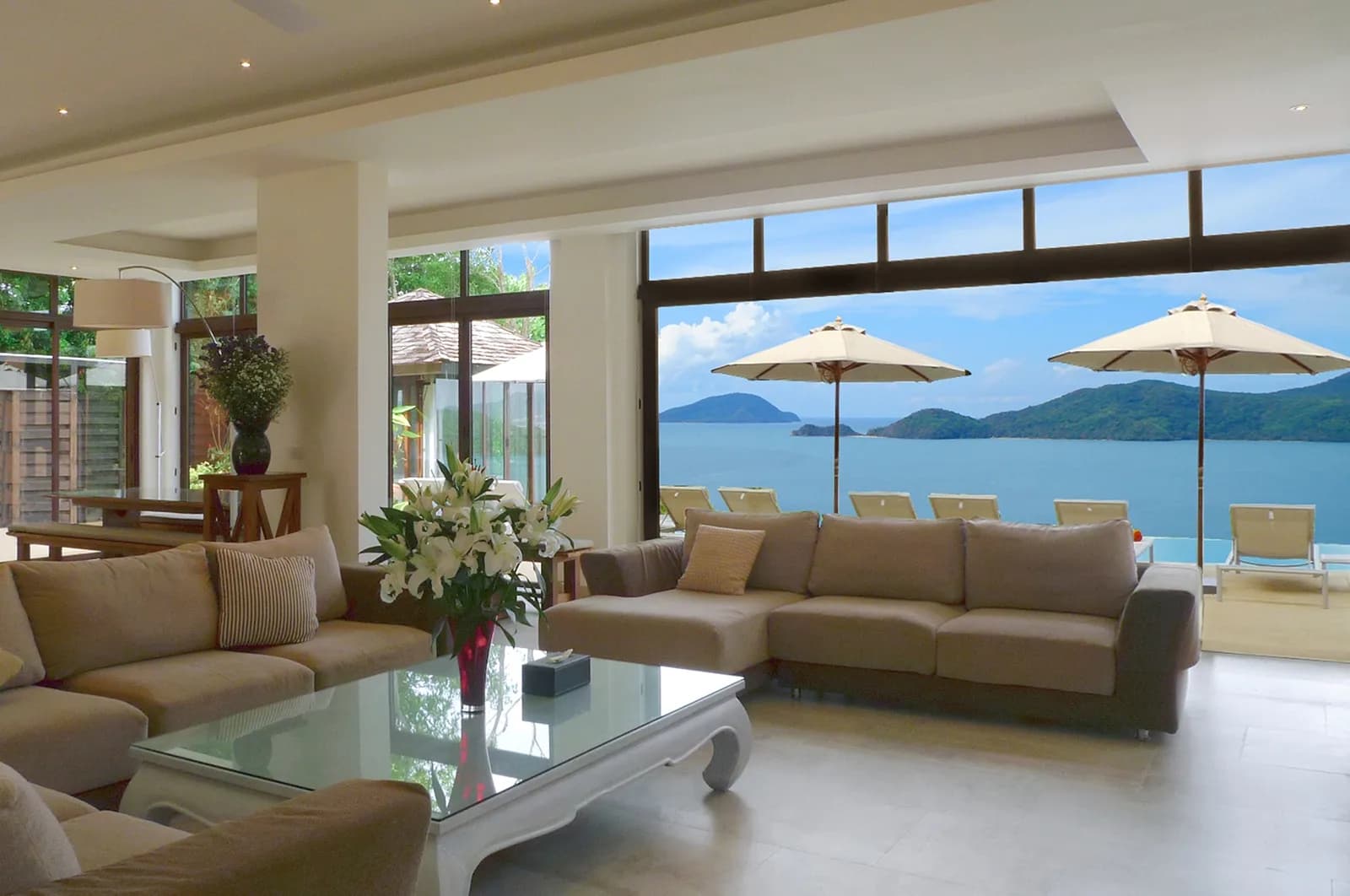 The huge 170sqm open-plan living room has stunning sea views, high ceilings, and fully-opening windows leading directly to the pool terrace.
