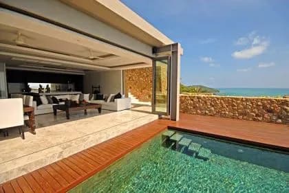 The lounge opening onto the pool with superb views