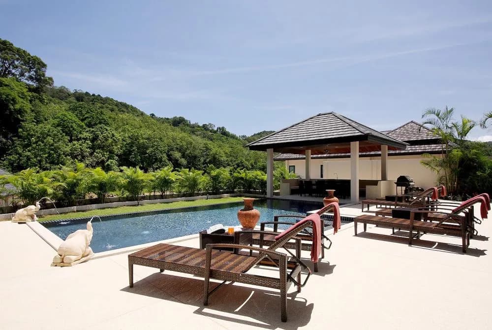 Swimming pool, surrounded by sundeck with plenty of sunbeds